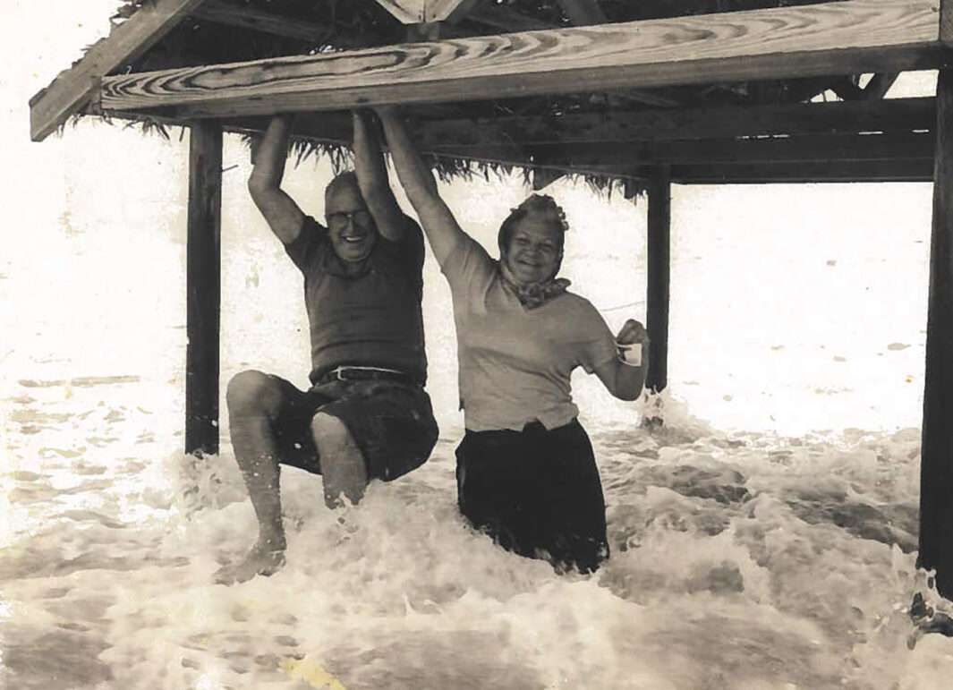 A couple playing in the tide at Dauphin Island. Image was featured from one of MB's top 10 stories of 2024